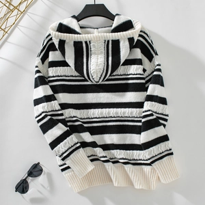 Detail of black and white striped knit hoodie with thick ribbed cuffs and hem