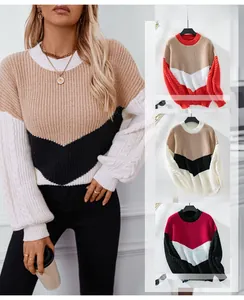 Detail eines Colorblock-Strickpullovers mit Zopfmuster-Laternenärmeln und Rundhalsausschnitt