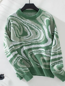 Detail of green and white abstract jacquard knit texture on a long sleeve sweater