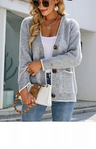 Detail of color-block knit cardigan with large buttons and front pockets for women
