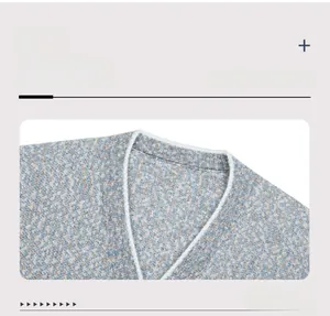 Detail of V-neckline with white contrast trim on blue tweed knitted cardigan sweater