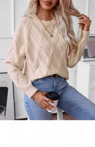 Detail view of cream diamond knit pattern and soft texture on women's loose crewneck sweater