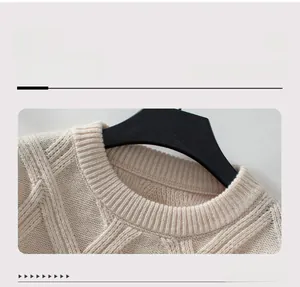 Detailed close-up of a beige crew neck knit sweater with diamond cable patterns