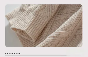 Macro detail of diamond knit pattern and ribbed cuff on beige crewneck sweater
