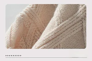 Close-up of beige diamond knit pattern showing soft texture and premium cable stitch detail