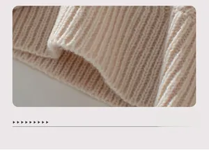 Close-up of beige knit sweater ribbed hem showcasing thick texture and quality weaving