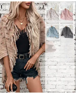 Detailed view of colorful knit texture and long fringe hem on casual loose shawl