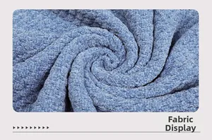 Detailed close-up of thick blue chenille knit fabric with soft textured grainy weave