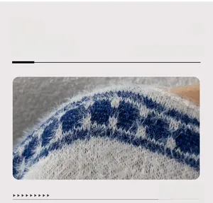 Close-up of boat neck knit sweater featuring blue and white jacquard pattern and soft texture