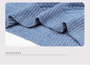 Macro shot of blue ribbed knit sweater fabric showing textured corduroy material details