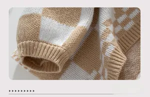 Macro shot of knitted sweater cuff featuring beige checkerboard pattern and ribbed texture