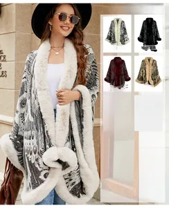 Close-up of knit poncho with faux fur trim and intricate feather jacquard pattern