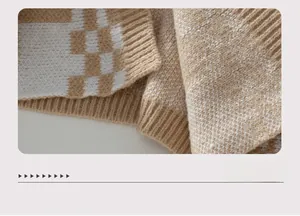 Detailed close-up of ribbed knit hem on a brown and white checkered pattern cardigan