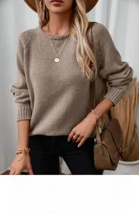 Detailed view of khaki knit sweater texture with rolled neck and chic accessories