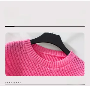 Detailed close-up of the round neckline and ribbed texture on this pink knitted sweater