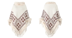 Detail of white knit poncho featuring brown snowflake patterns, faux fur trim and fringe