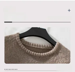 Detail of a light brown crew neck knit sweater showing the ribbed collar texture
