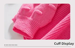 Close-up of bright pink knitted sweater sleeve with ribbed cuffs and unique puff texture