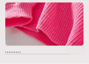 Detailed macro view of the hot pink ribbed knit hemline on a cozy women's sweater