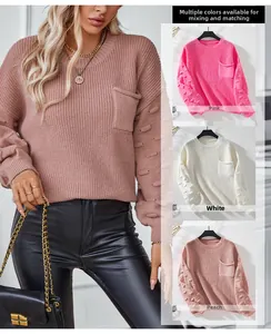Detail of knit sweater showing pocket design and textured bubble sleeves in multiple colors