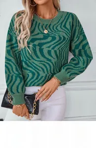 Detail of green zebra pattern knit sweater showing ribbed cuffs and soft fabric texture