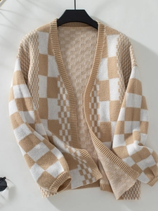 Detail of khaki and white checkerboard knit cardigan with ribbed cuffs and soft texture