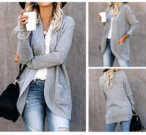 Detail of grey waffle knit cardigan showing large pockets and long open front design
