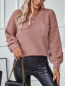 Women's pink knit sweater with bubble sleeves, pom-pom texture and chest pocket detail