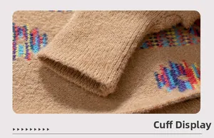 Detail of ribbed cuffs on Aztec cardigan featuring plush jacquard fabric and fringe trims