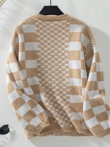Detail view of khaki and cream checkerboard knit sweater with ribbed cuffs and collar