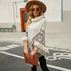 Women's knit hooded poncho cape with faux fur trim, geometric patterns and tassel hem