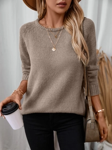 Detail of loose fit khaki round neck sweater with thick knitted texture and rolled edges