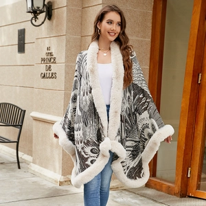 Elegant knit poncho for women featuring peacock patterns and faux fur trim for winter warmth
