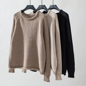 Detail of raglan sleeves and ribbed knit texture on three casual crewneck sweaters