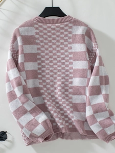 Detail of pink and white checkered knit sweater featuring textured ribbed cuffs and hem