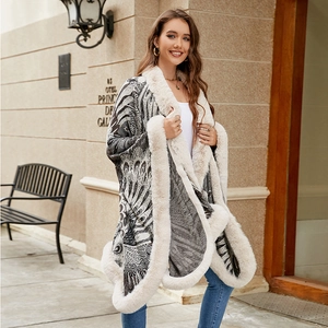 Women's knitted peacock pattern poncho with plush faux fur trim in black and grey