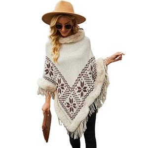 Women's knit hooded poncho cape with snowflake pattern, faux fur trim and fringed hem