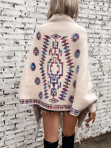 Bohemian Aztec knit cardigan with geometric ethnic pattern and fringe details on back