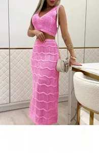 Macro detail of bright pink crochet knit set with intricate wavy texture and mesh weave