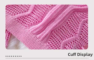 Detailed close-up of pink knit hollow-out crop top showing cuff weaving and wavy texture