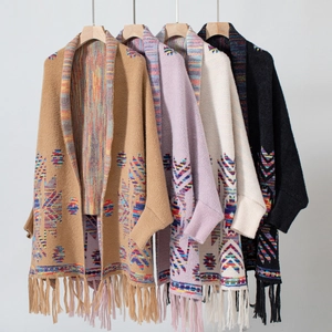 Detail of geometric knit cardigans with bohemian tassels in four assorted colors
