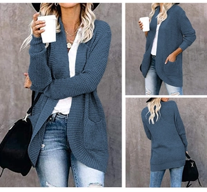 Blue waffle knit cardigan featuring large side pockets and ribbed cuffs in detail view