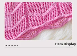 Detailed close-up of pink hollow-out knit hem on soft white faux fur background