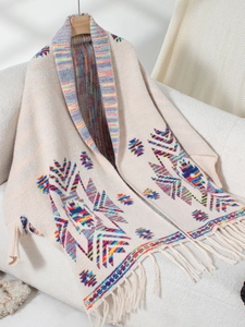 Detail of Aztec knit cardigan featuring geometric tribal patterns and fringe tassels