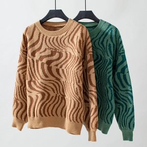 Close-up of zebra pattern knit sweater with ribbed cuffs and round neck detail