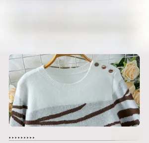 Detail of round neckline and gold shoulder buttons on zebra-striped knit sweater