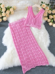 Pink knit two-piece set featuring a V-neck crop top and matching hollow-out maxi skirt
