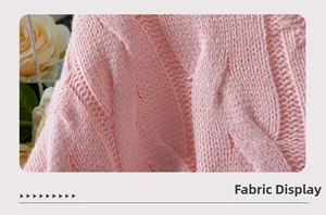 Detail of pink cable knit fabric texture showing intricate soft woven patterns and finish