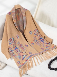 Detail of bohemian knit cardigan with colorful Aztec patterns and fringe hem decor