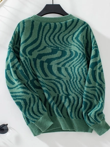 Detail of green zebra print knit sweater showing ribbed crew neck and textured fabric